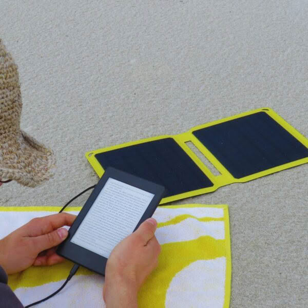 SunSaver Power-Boost charging an ereader at the beach